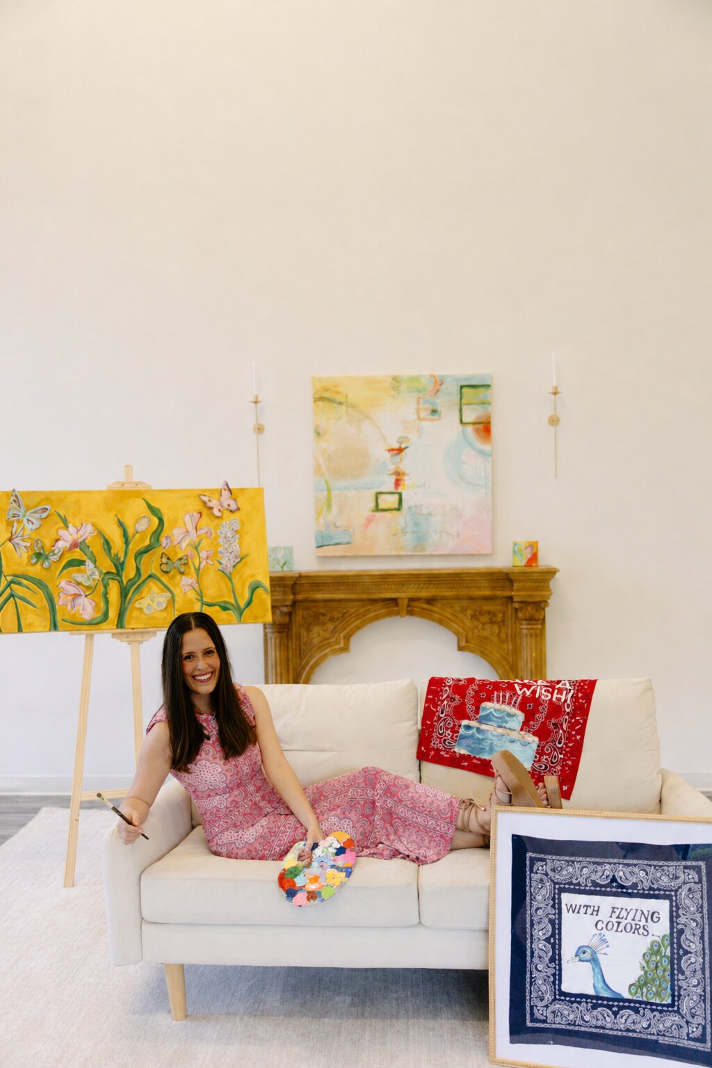 Gracie Crabtree seated in her studio surrounded by her artwork